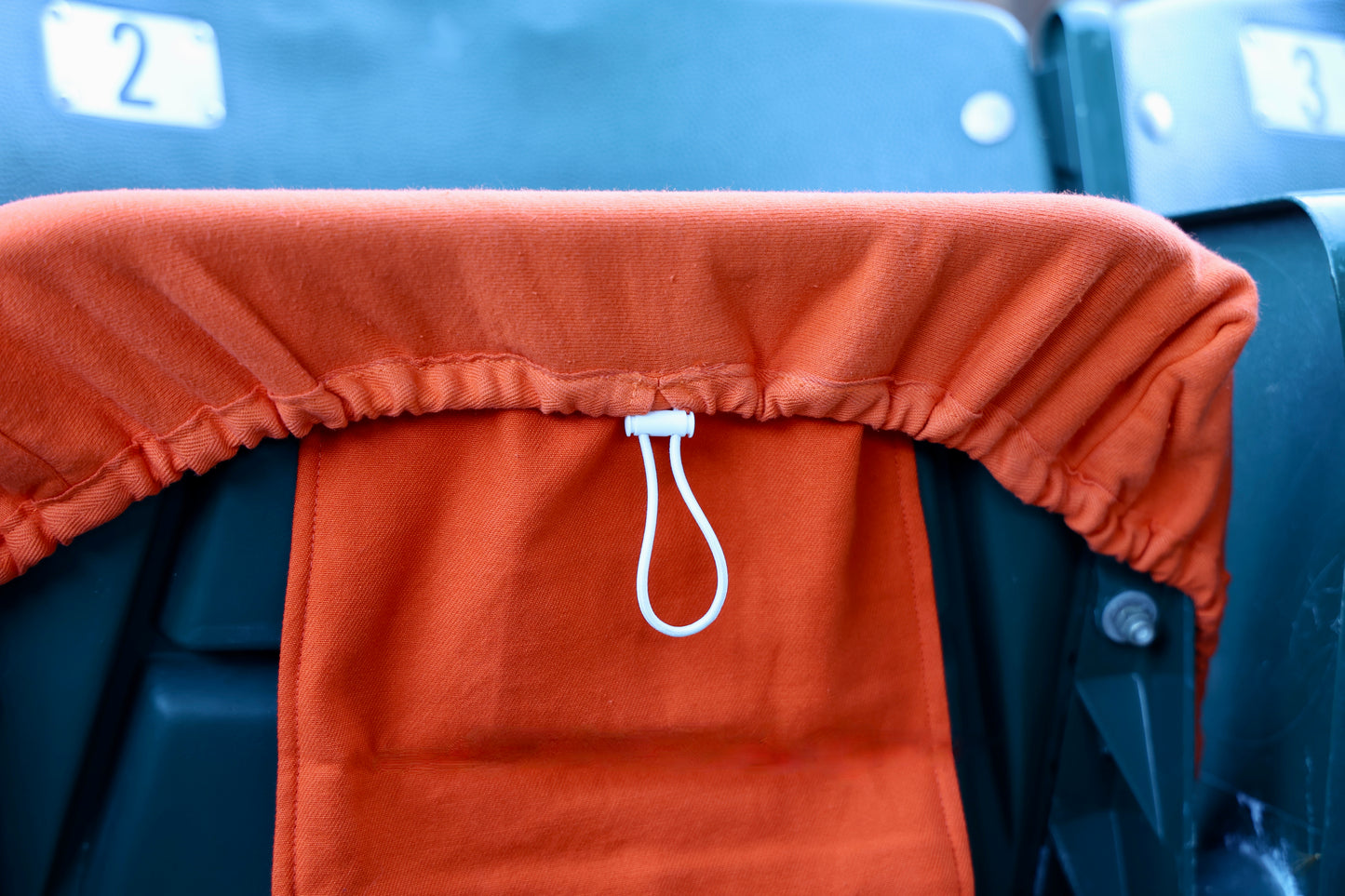 orange seat cover close up toggle and bag